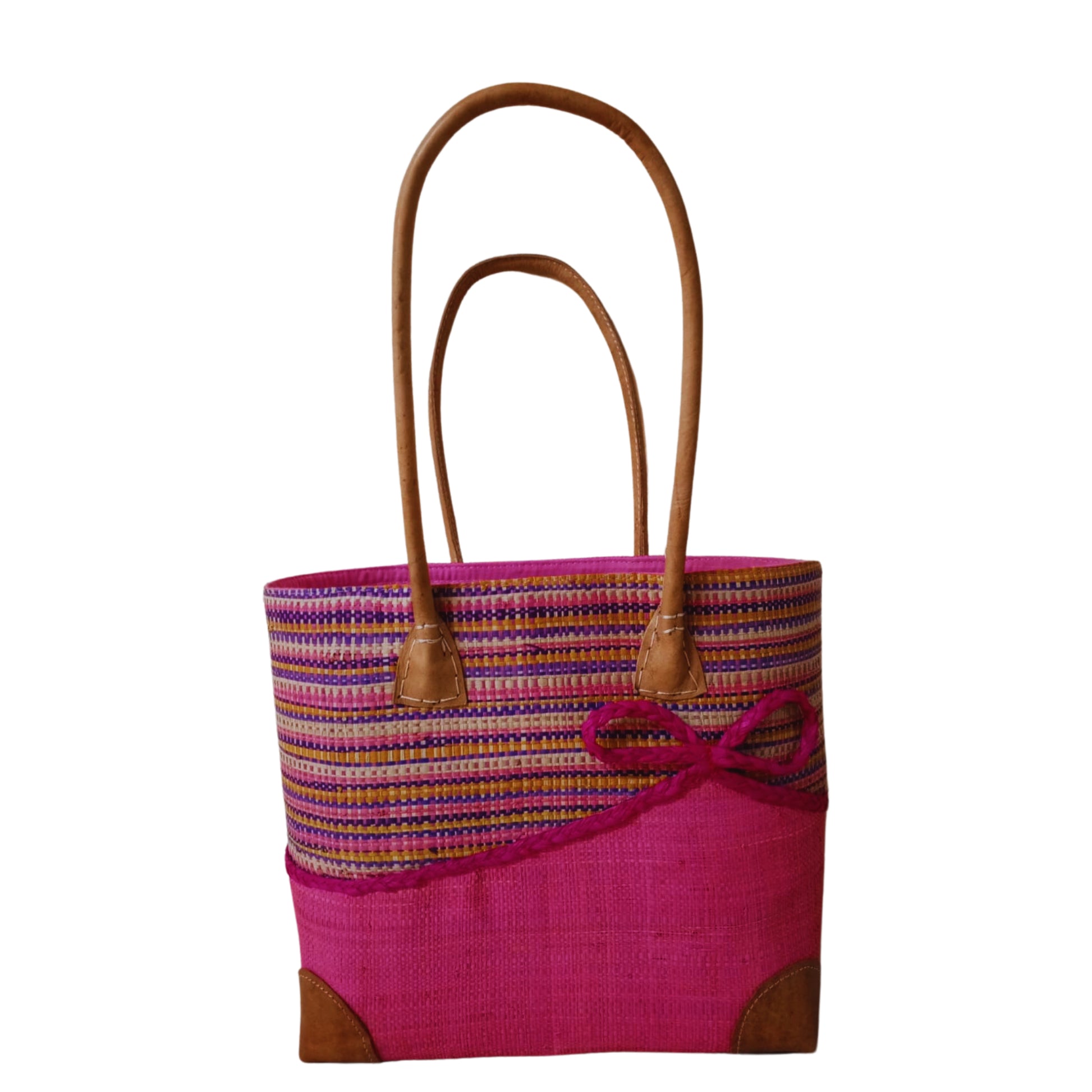 Baby Pink woven basket with a bow at the front. Handmade in Madagascar. 