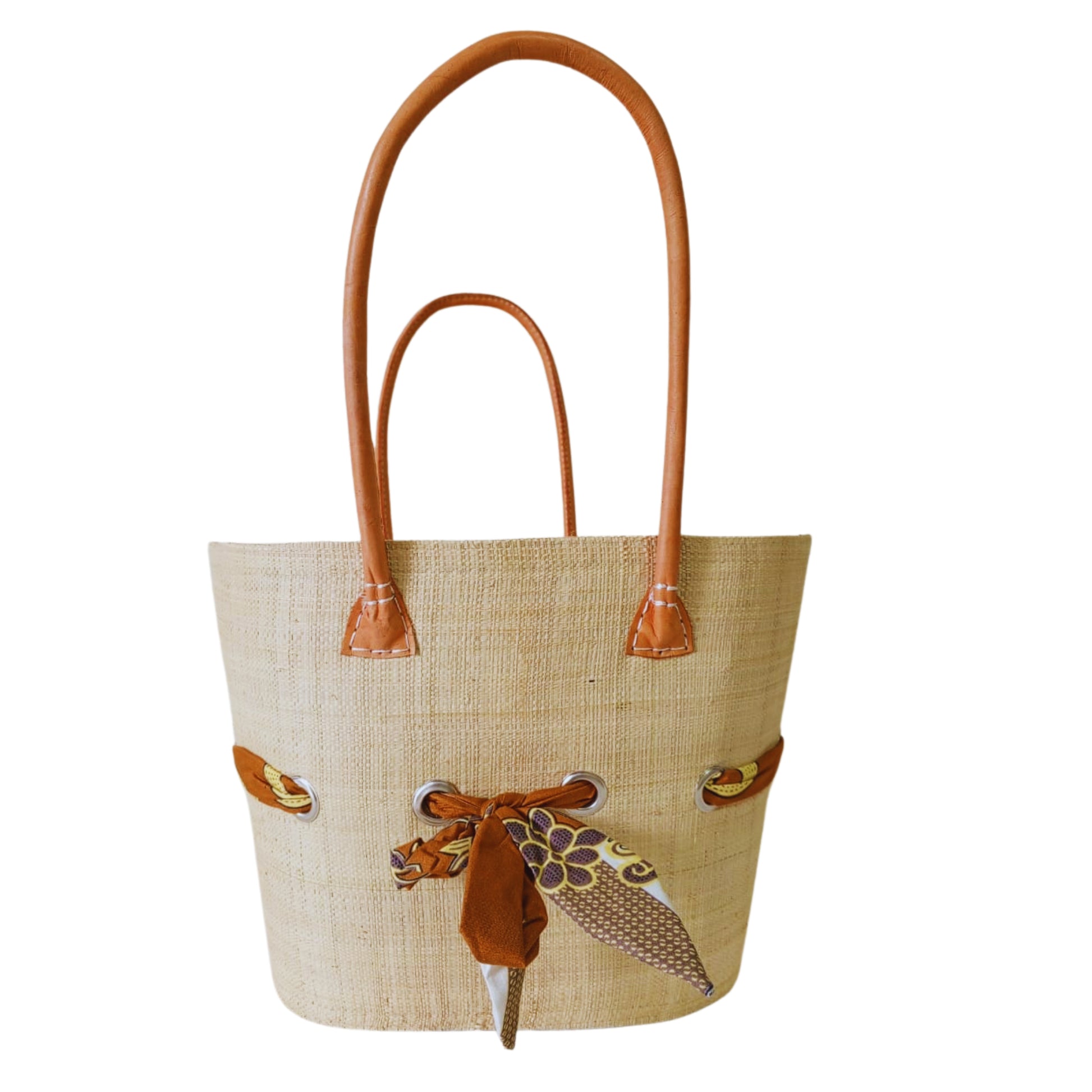 Beige raffia woven basket with a fabric bow tied features. Handmade in Madagascar