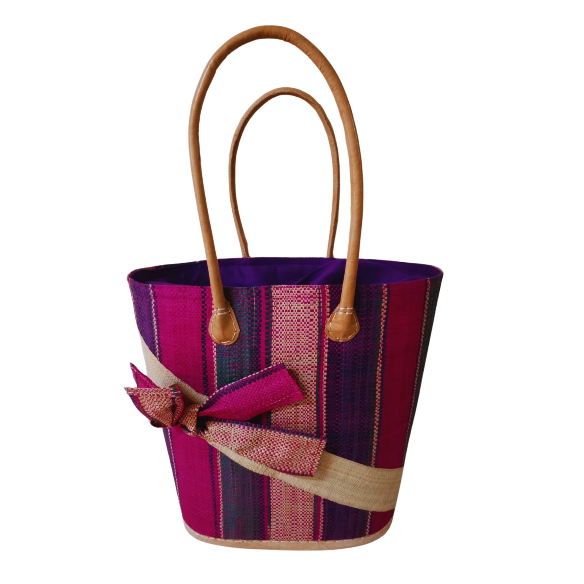 Pink woven basket with a raffia bow. Handmade in Madagascar. 