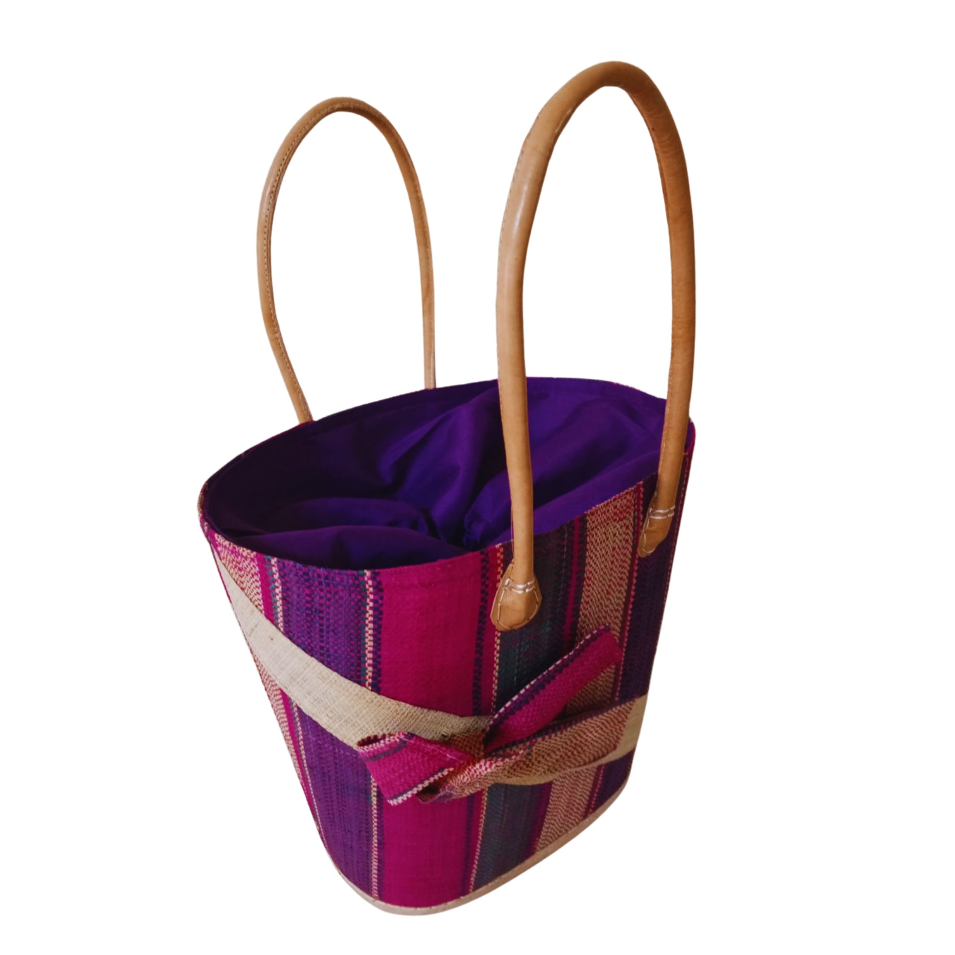 Pink woven basket with a raffia bow. Handmade in Madagascar. 