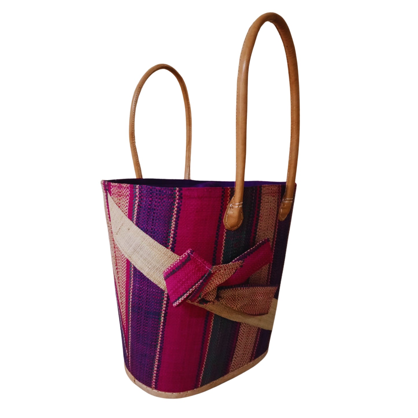 Pink woven basket with a raffia bow. Handmade in Madagascar. 