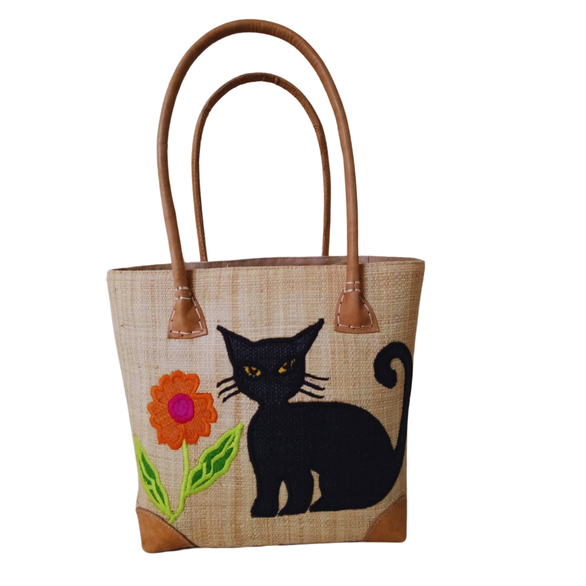 Beige woven basket with cat embroidery, leather handle and drawstring closure. handmade in Madagascar. 