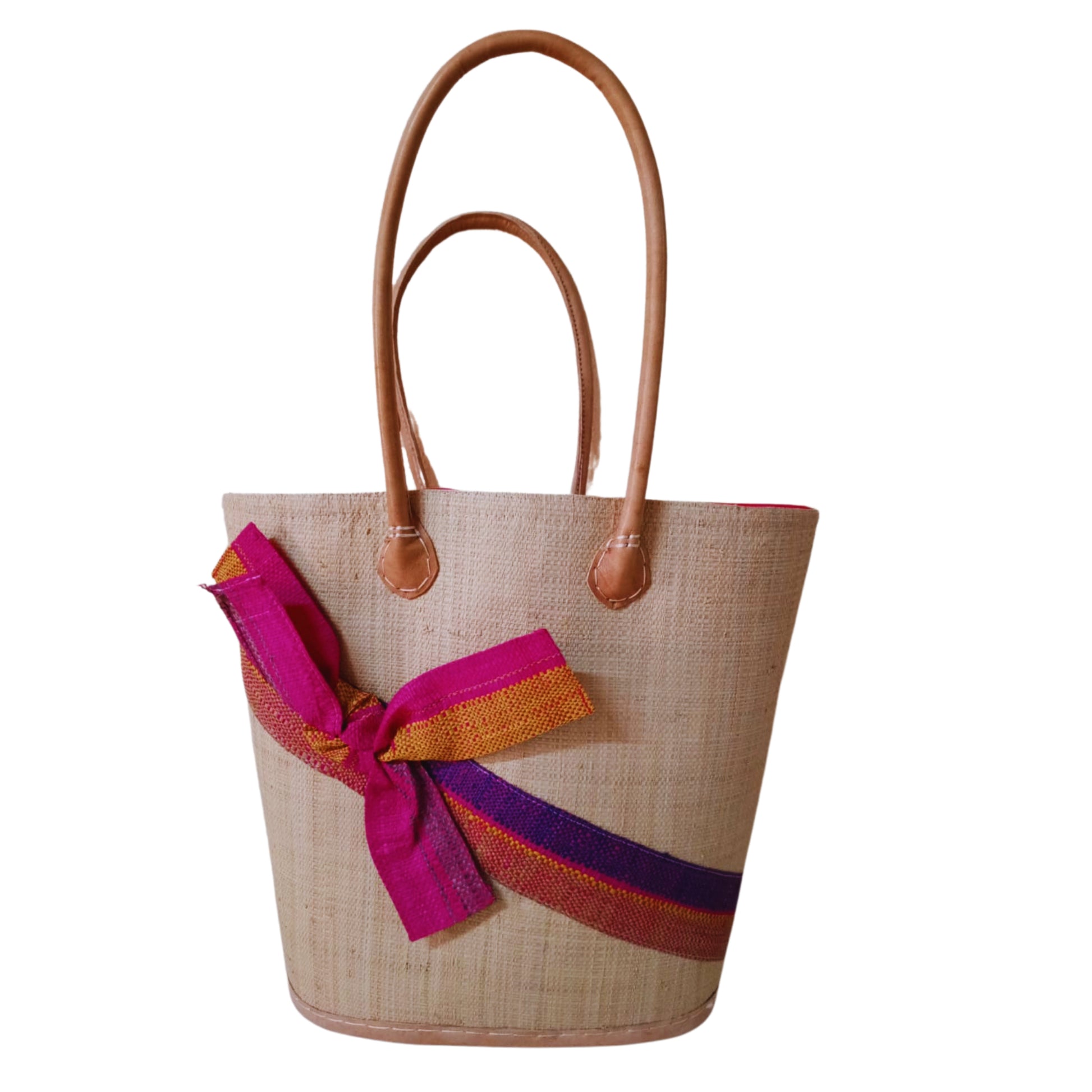 Beige and Pink woven basket with a raffia bow. Handmade in Madagascar. 