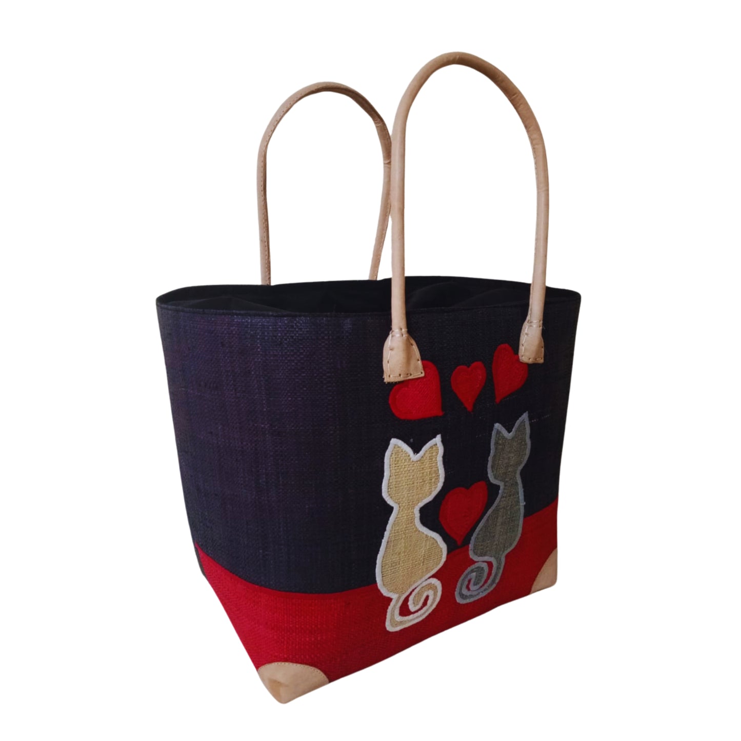 Woven baskets with cat embroidery, leather handle and drawstring closure. Handmade in Madagascar