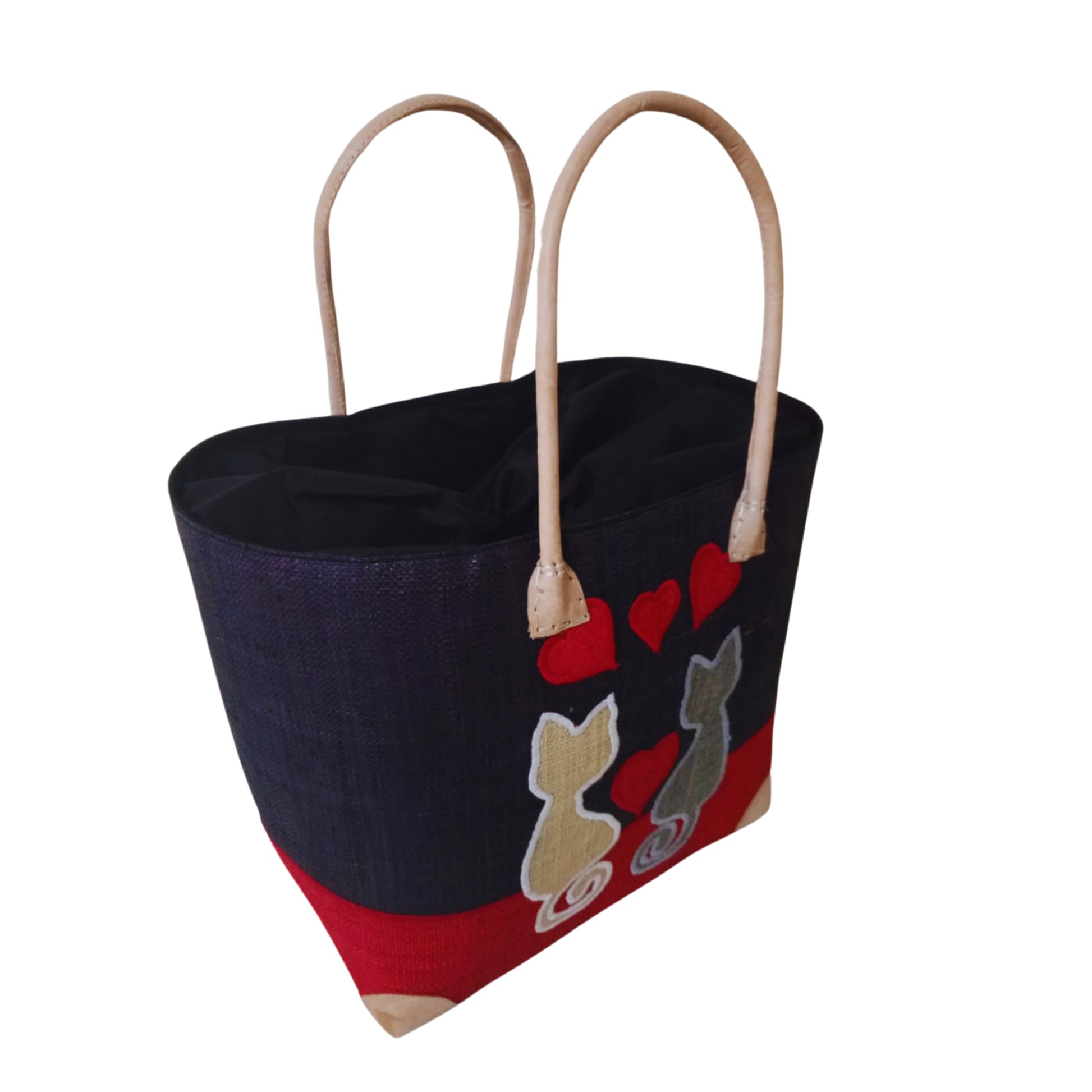 Woven baskets with cat embroidery, leather handle and drawstring closure. Handmade in Madagascar