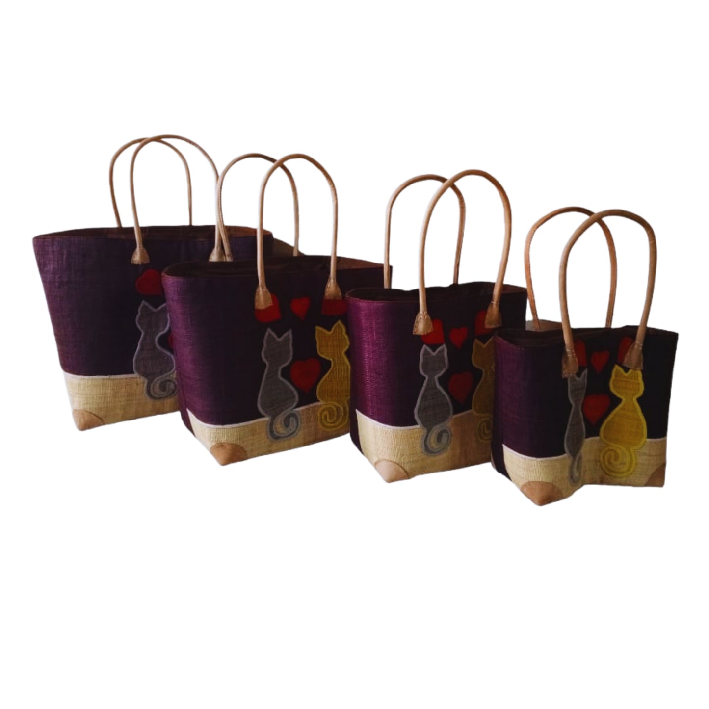 Woven baskets with cat embroidery, leather handle and drawstring closure. Handmade in Madagascar