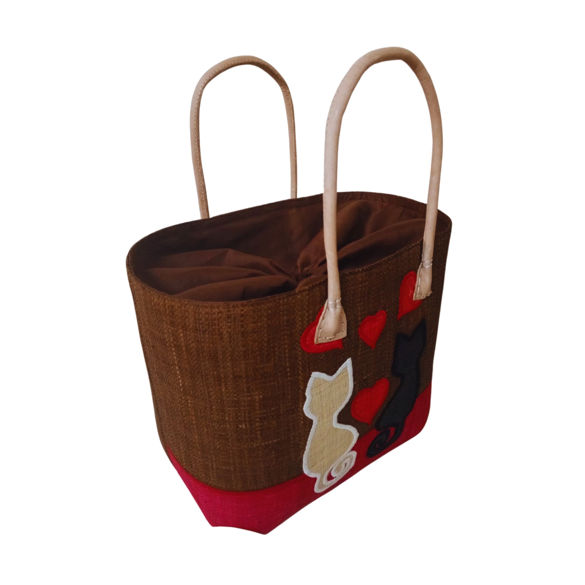 Woven baskets with cat embroidery, leather handle and drawstring closure. Handmade in Madagascar