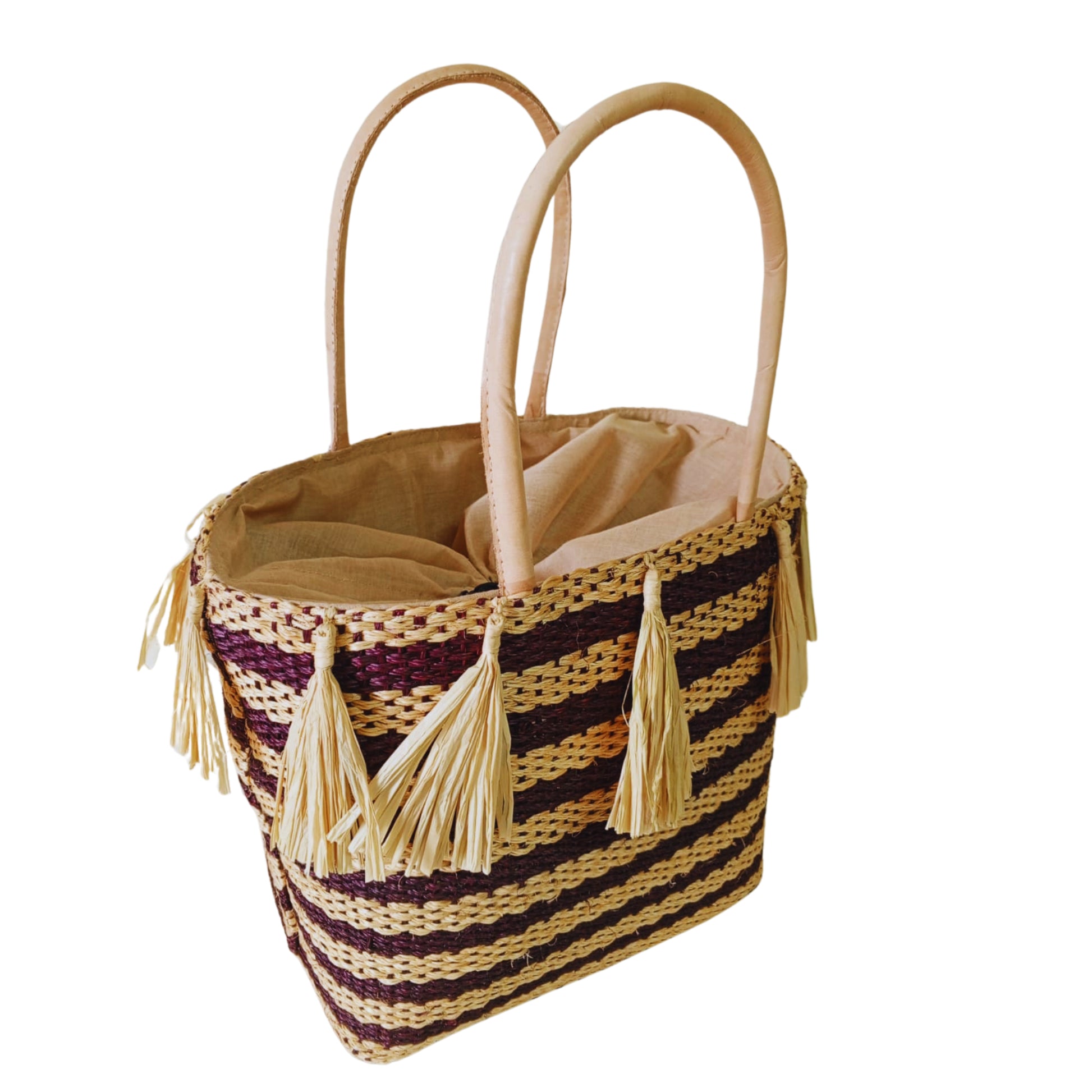 Brown handmade woven basket with tassel. Leather handle and drawstring closure. Handmade in Madagascar 