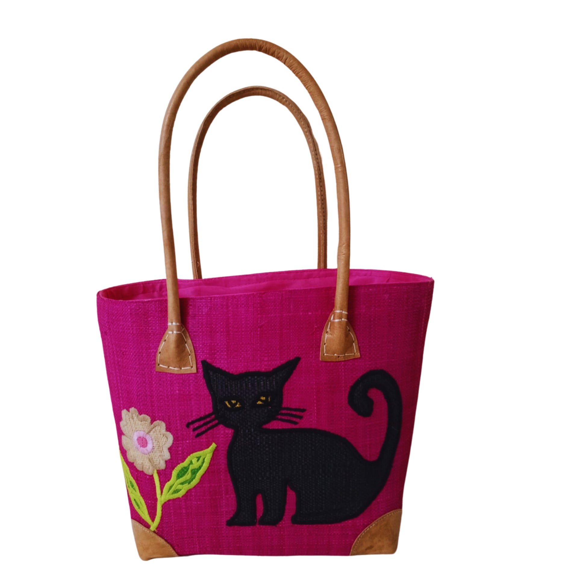 Pink woven basket with cat embroidery, leather handle and drawstring closure. handmade in Madagascar. 