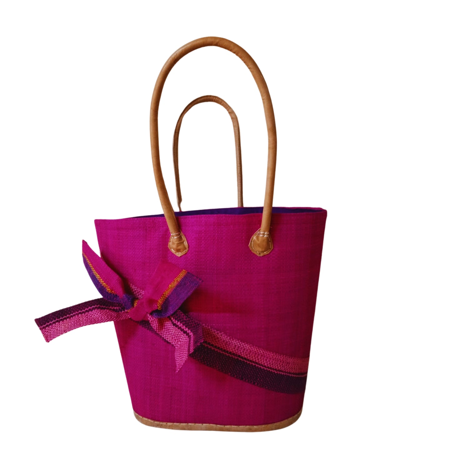 Pink woven basket with a raffia bow. Handmade in Madagascar. 