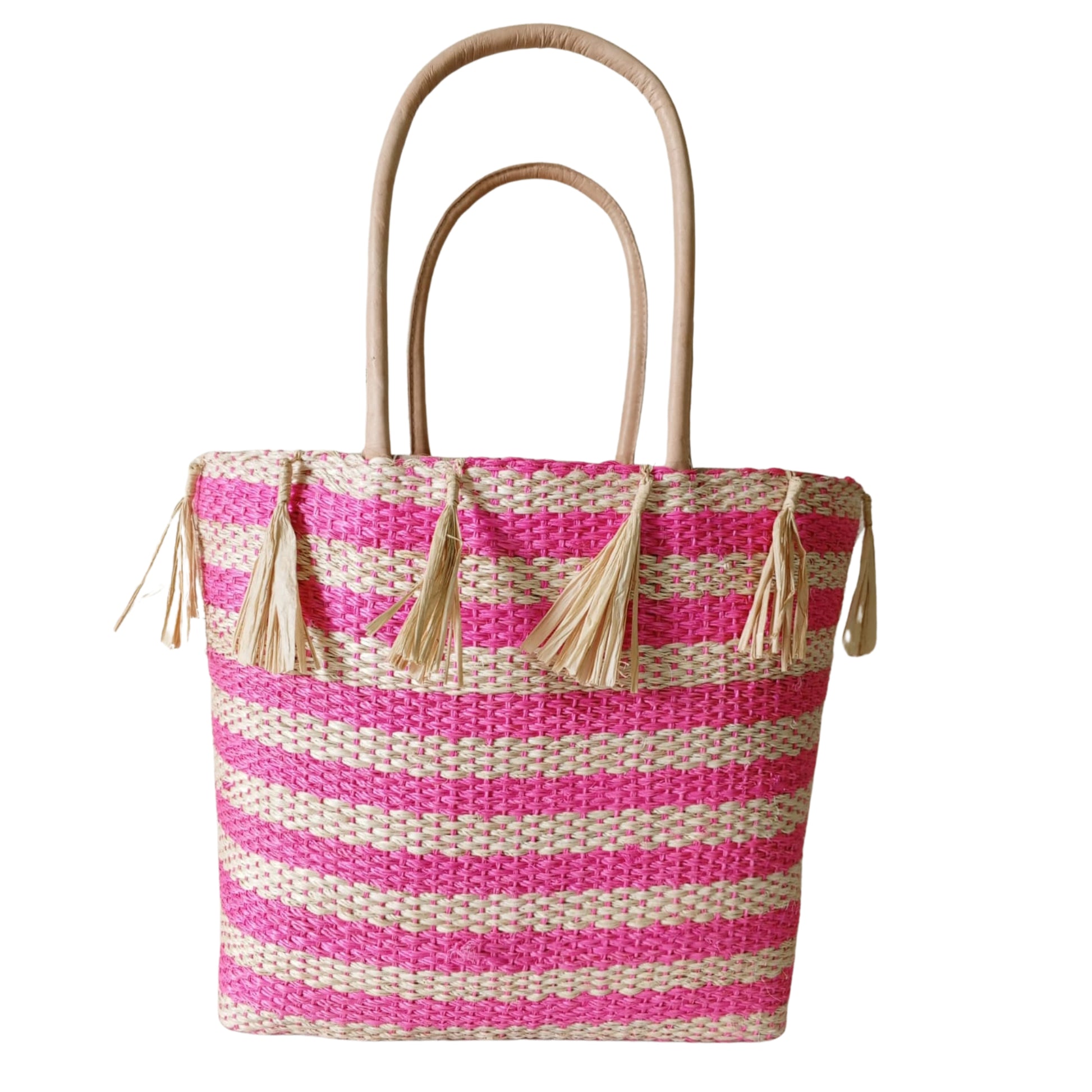 Pink handmade woven basket with tassel. Leather handle and drawstring closure. Handmade in Madagascar 