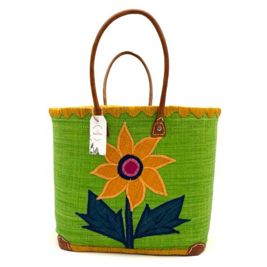 Green raffia basket with sunflower embroidery on the front and back. It has a leather handle. Handmade with love in Madagascar.