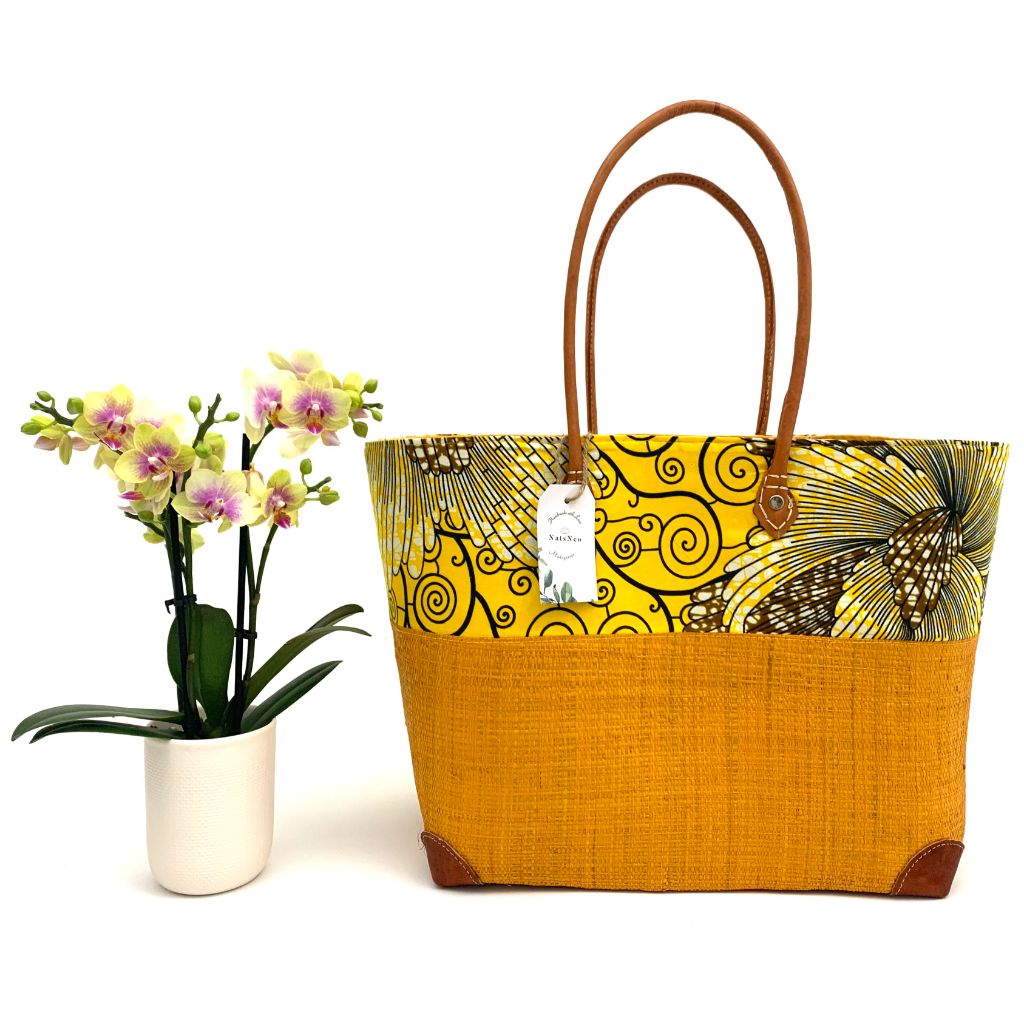 Yellow raffia basket in 3 different sizes,half raffia and half tissue wax, with  inside pockets & leather handle.Handmade in Madagascar with love. 