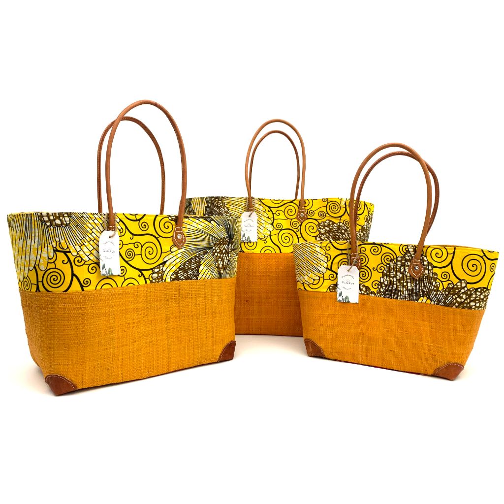 Yellow raffia basket in 3 different sizes,half raffia and half tissue wax, with  inside pockets & leather handle.Handmade in Madagascar with love. 